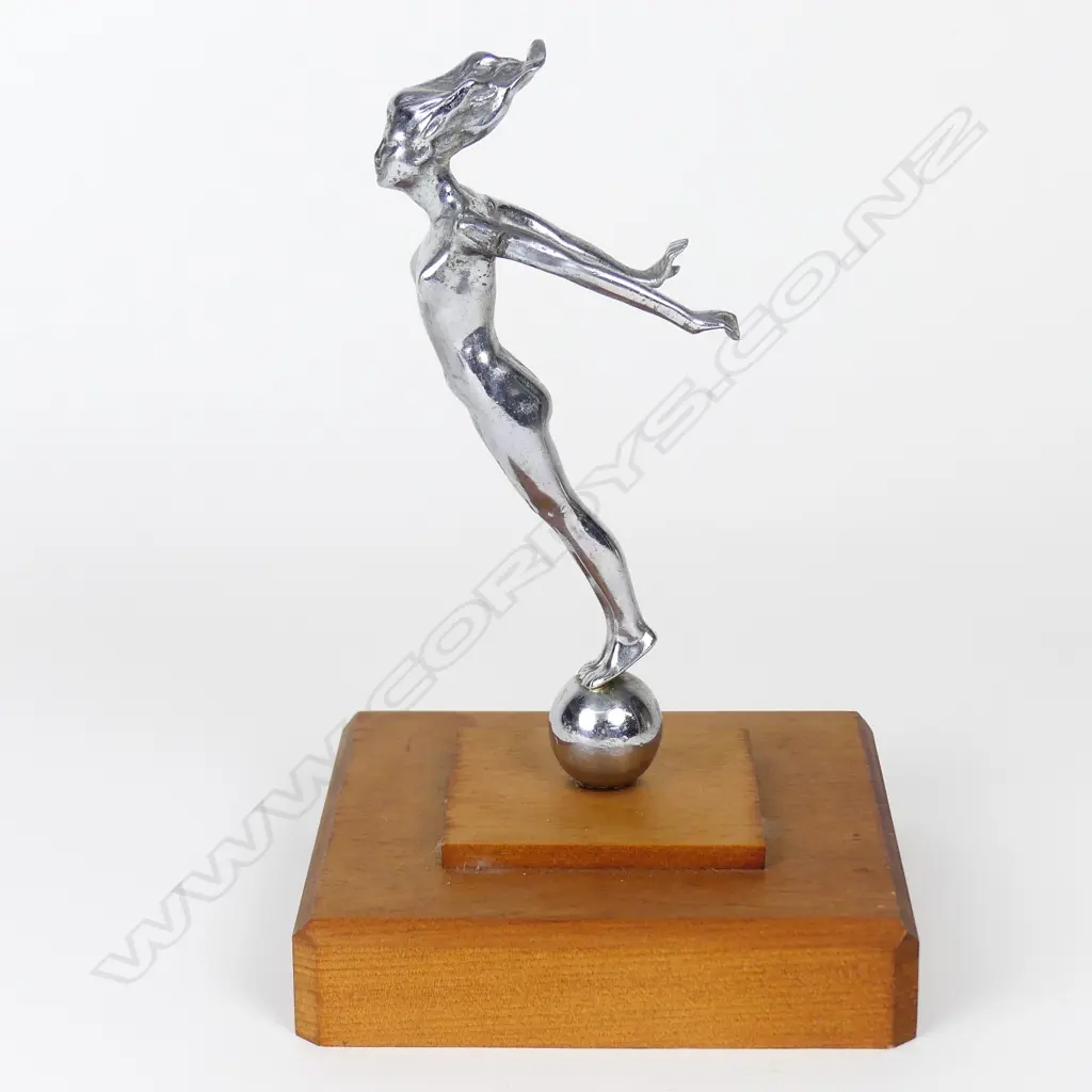 A vintage car mascot of a chromed naked woman Image 1++