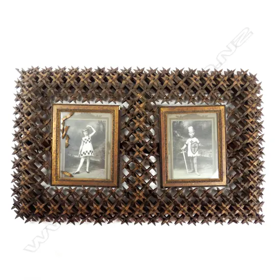 An antique 'tramp art' carved picture frame