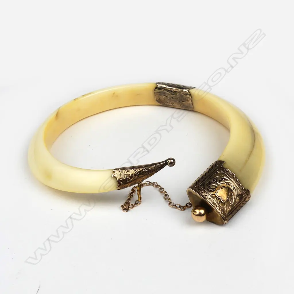 A large colonial 9ct gold and boar’s tusk bangle Image 1++