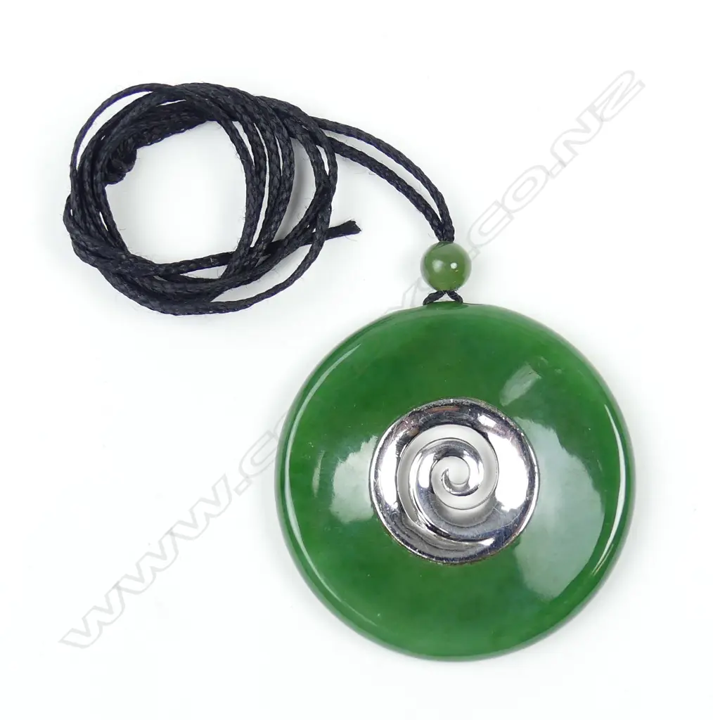 A modern N.Z. greenstone and silver disc form pendant Image 1++