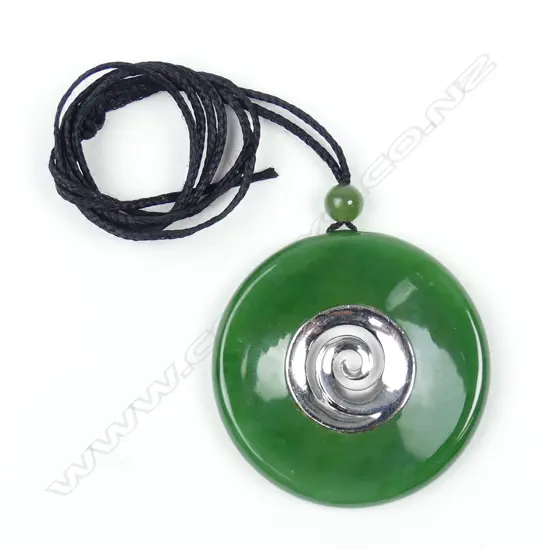 A modern N.Z. greenstone and silver disc form pendant