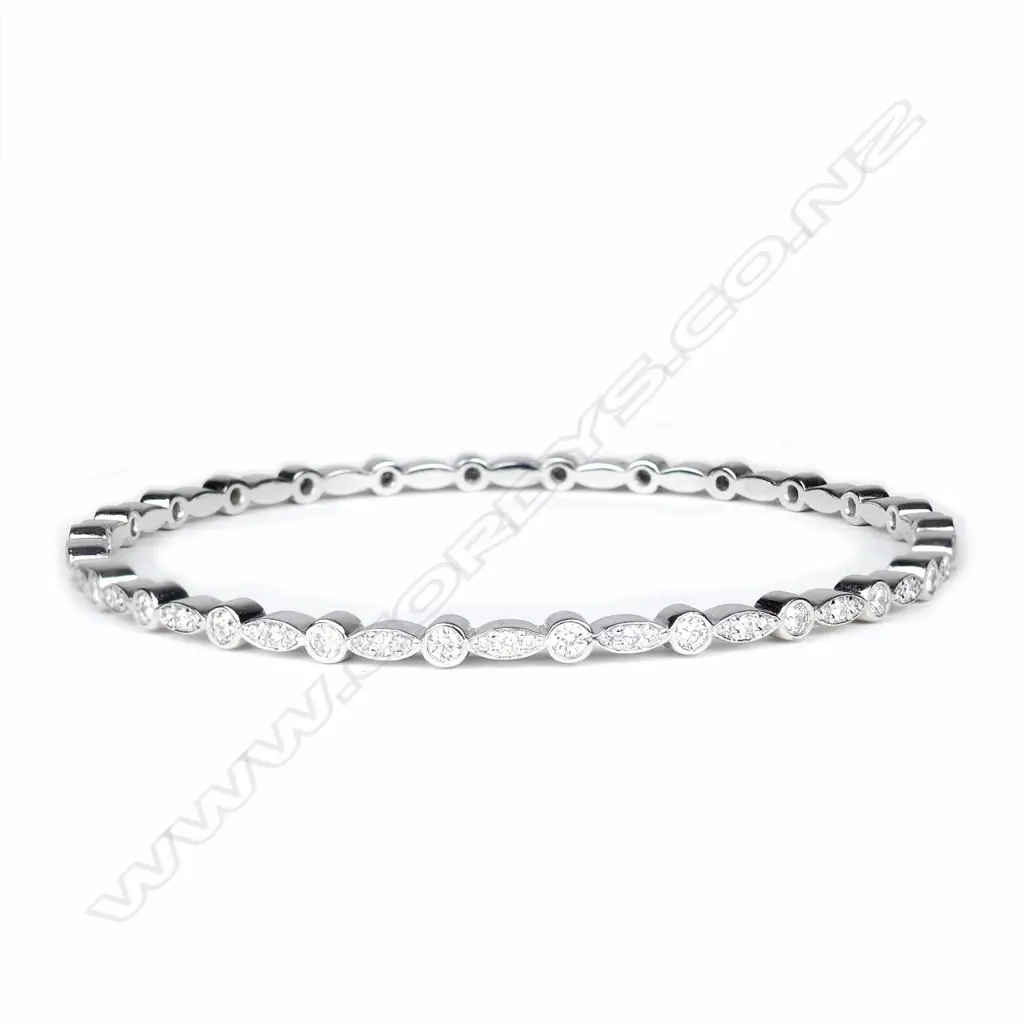 A modern 18ct. white gold and multi-diamond set bangle Image 1++