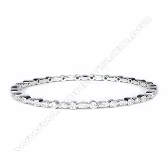 A modern 18ct. white gold and multi-diamond set bangle