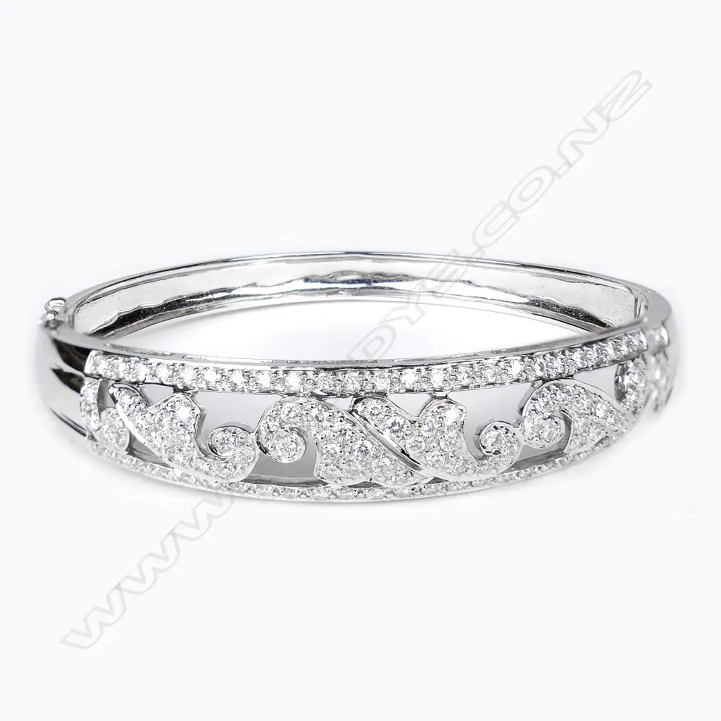 An 18ct white gold and diamond hinged bangle Image 1++