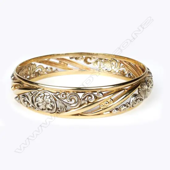 A 9ct yellow and white gold bangle