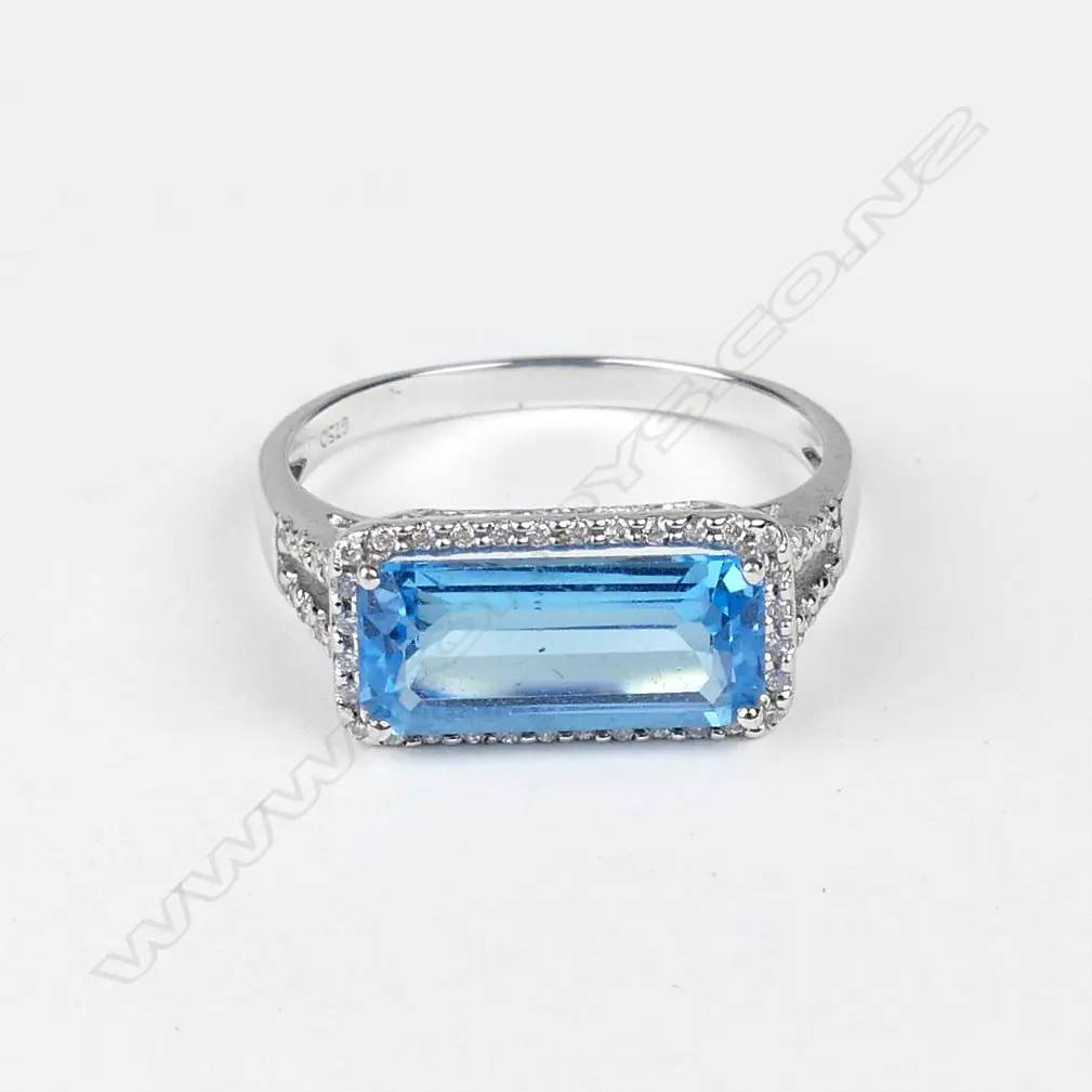 An 18ct white gold blue topaz and diamond ring and pendant set Image 1++