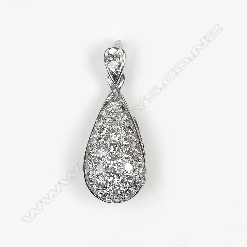 A modern 18ct. white gold and diamond encrusted pendant locket Image 1++