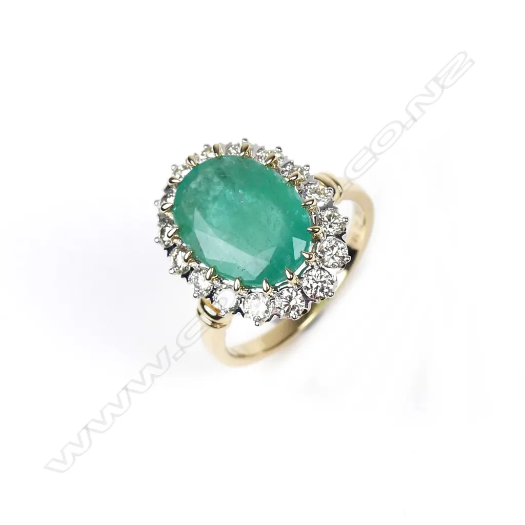 A 14ct gold emerald and diamond ring Image 1++