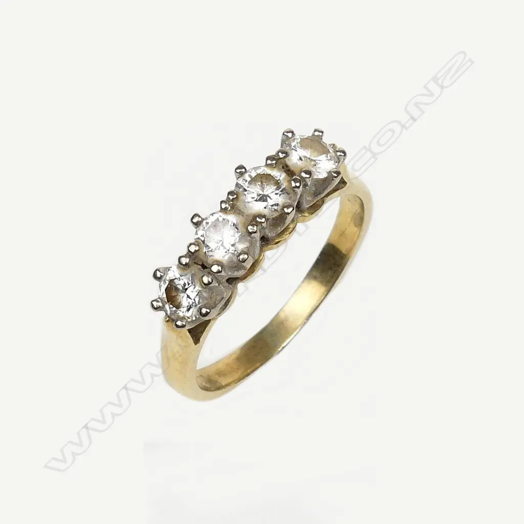 An 18ct gold and four stone diamond ring Image 1++