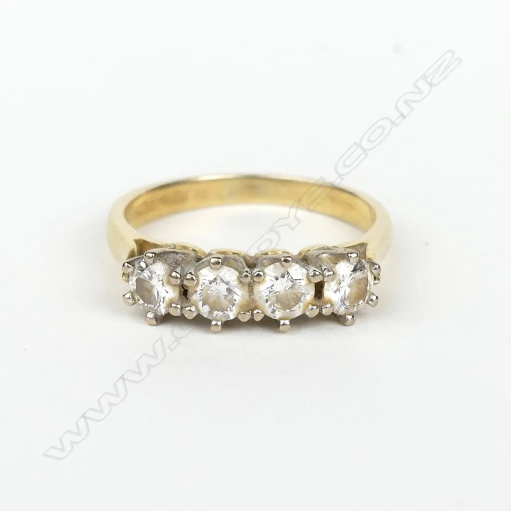 An 18ct gold and four stone diamond ring Image 1++