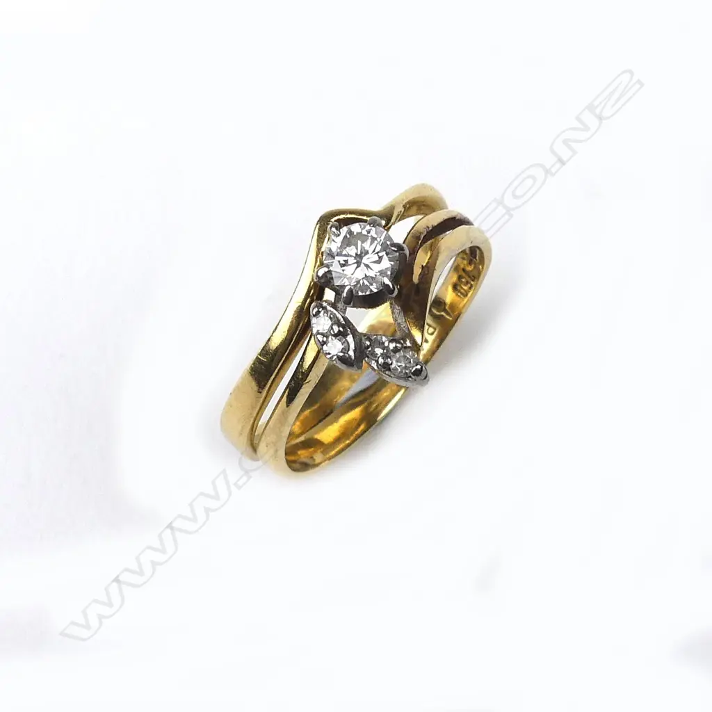 A pair of 18ct gold and diamond rings Image 1++