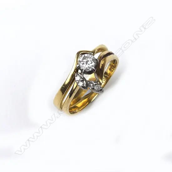 A pair of 18ct gold and diamond rings