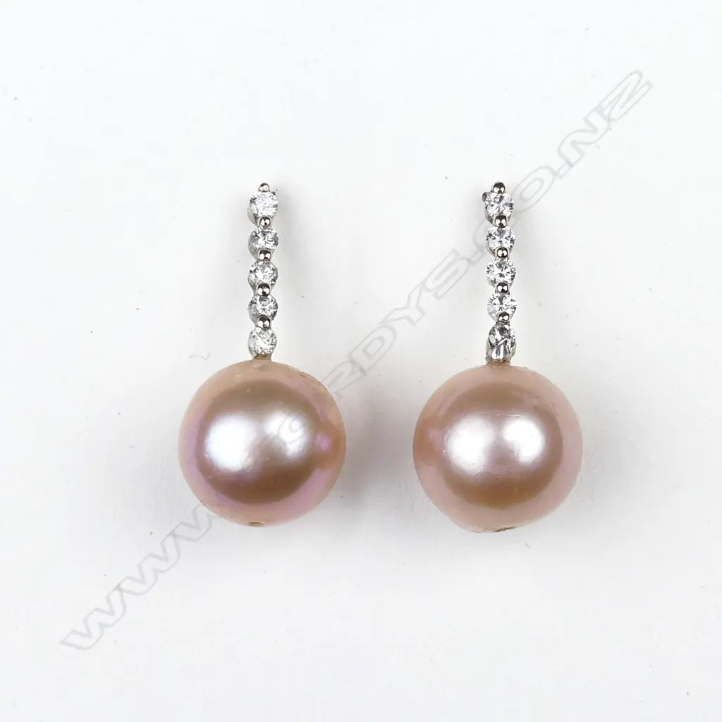 A pair of 14ct white gold pearl and diamond earrings Image 1++