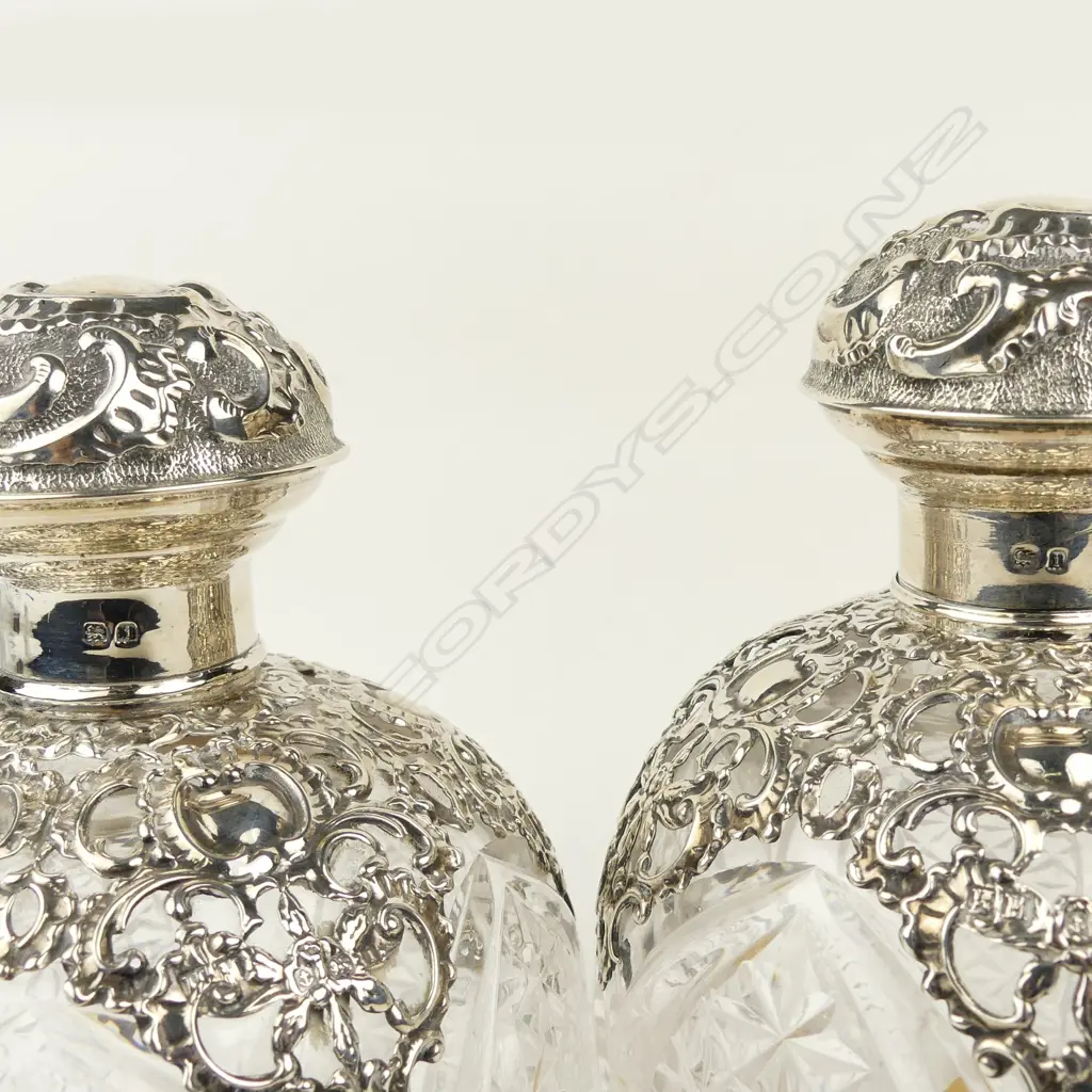 A pair of impressive Edwardian silver topped crystal scent bottles Image 1++