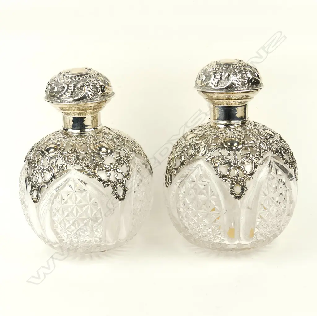 A pair of impressive Edwardian silver topped crystal scent bottles Image 1++