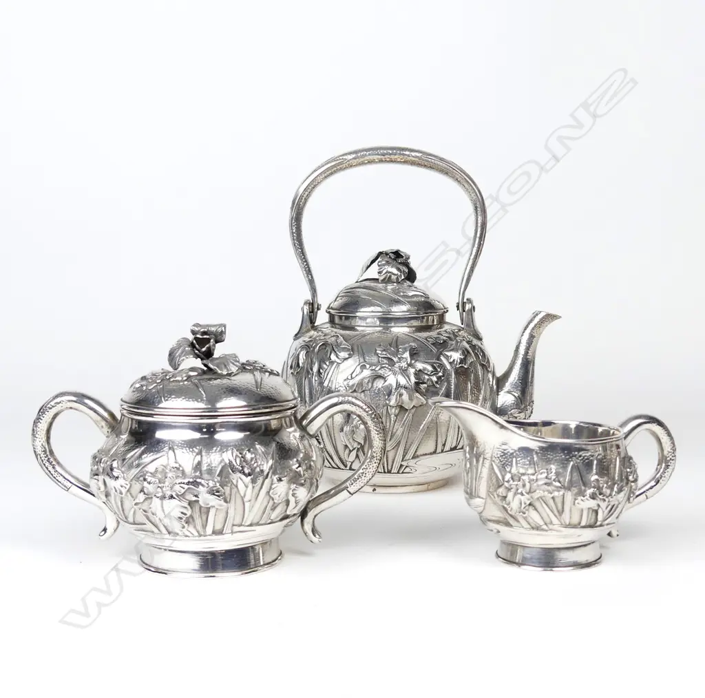 A Japanese Meiji iris decorated three-piece silver tea set Image 1++