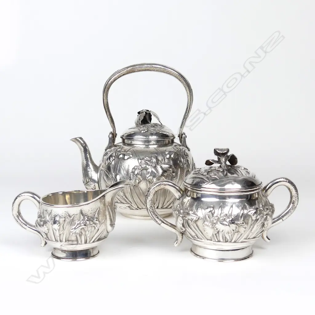 A Japanese Meiji iris decorated three-piece silver tea set Image 1++