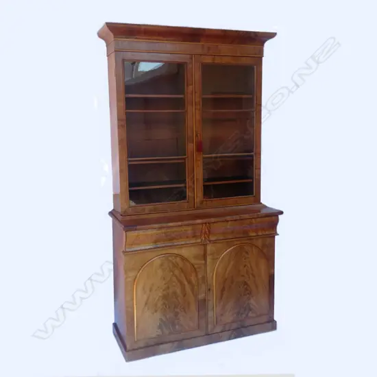 A William IV flame mahogany bookcase on cabinet