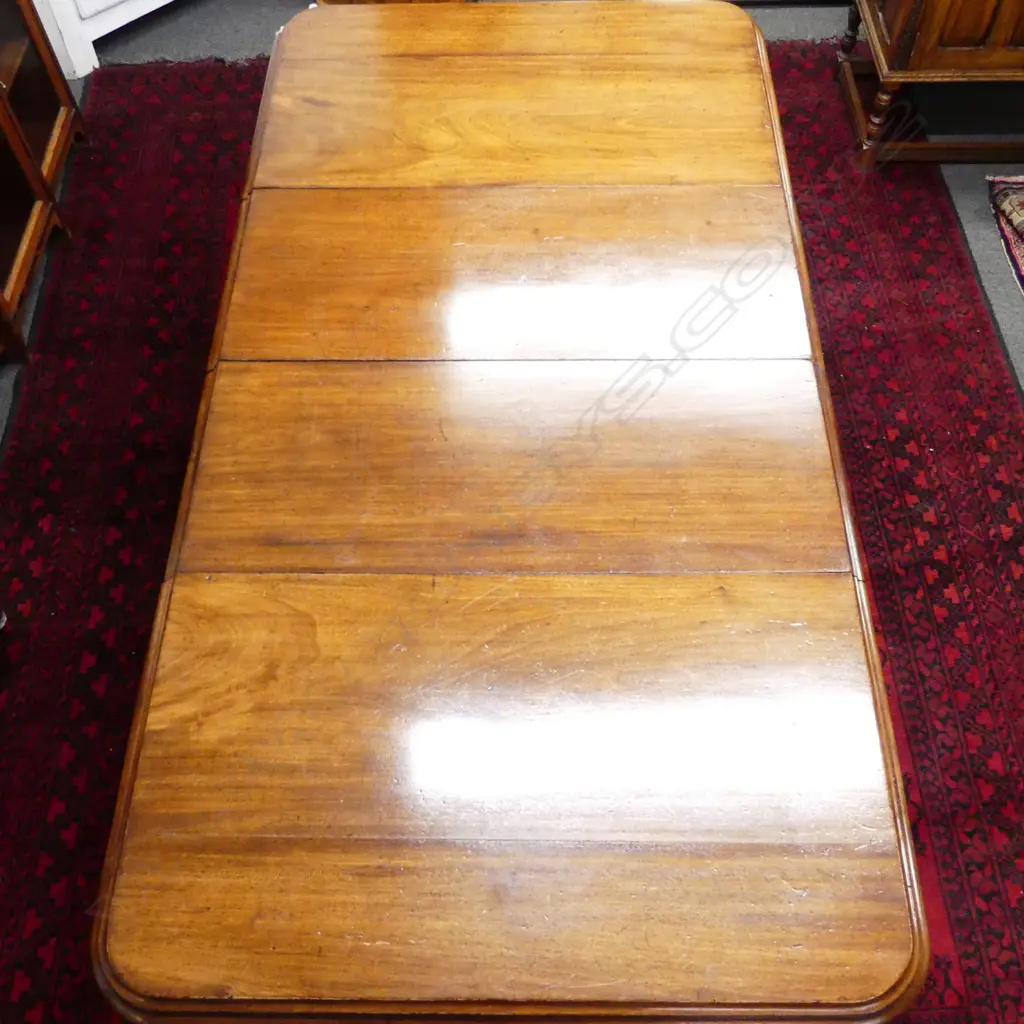 A Victorian mahogany crank extension dining table Image 1++