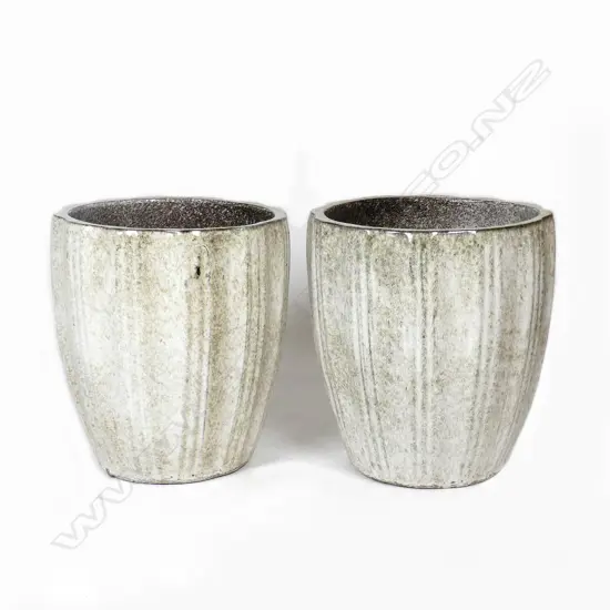 A pair of pale green and ivory mottled glazed garden pots