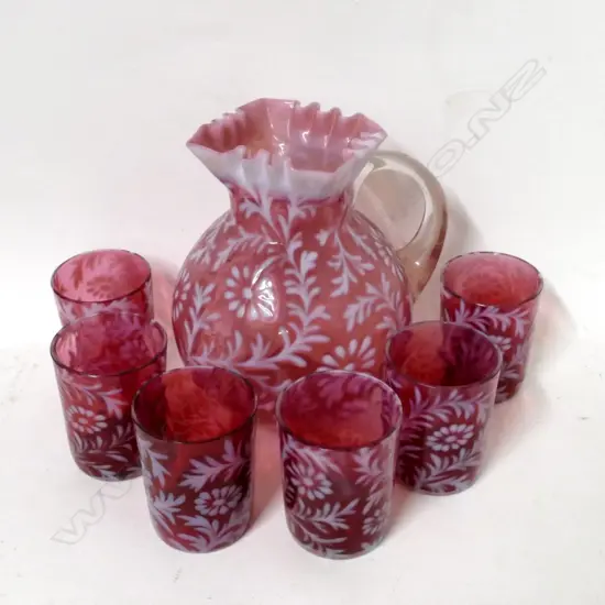 A cranberry glass jug and glasses set