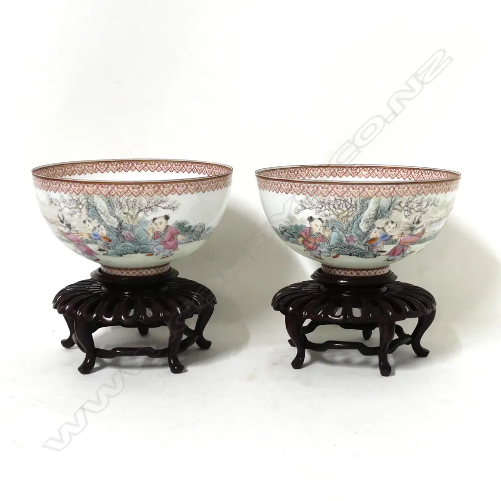 A pair of fine quality Chinese famille rose egg-shell porcelain circular bowls on short feet painted with scenes of young boys playing in a garden Image 1++