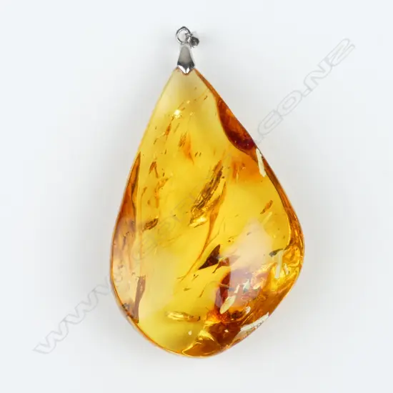 A large clear polished amber pendant