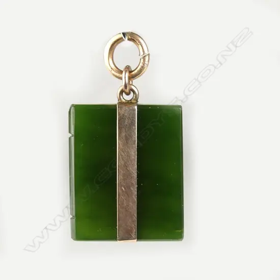 An early 20thC greenstone and 9ct. gold mounted book form pendant