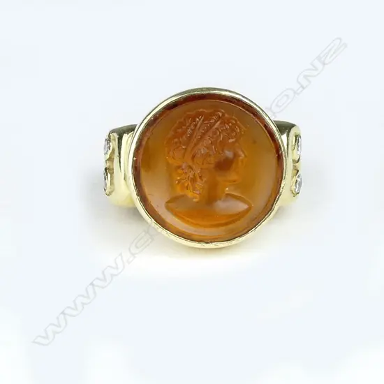 An 18ct. gold topaz coloured panel and diamond ring