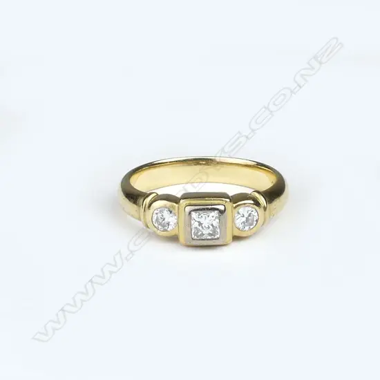 A lady's modern 18ct. yellow gold three-stone diamond ring