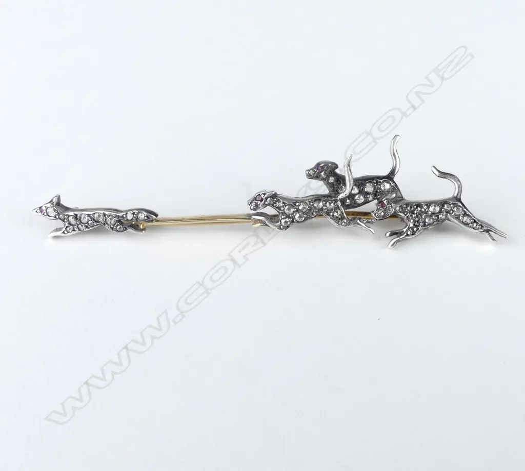 A decorative gold silver and diamond set fox hunting brooch Image 1++