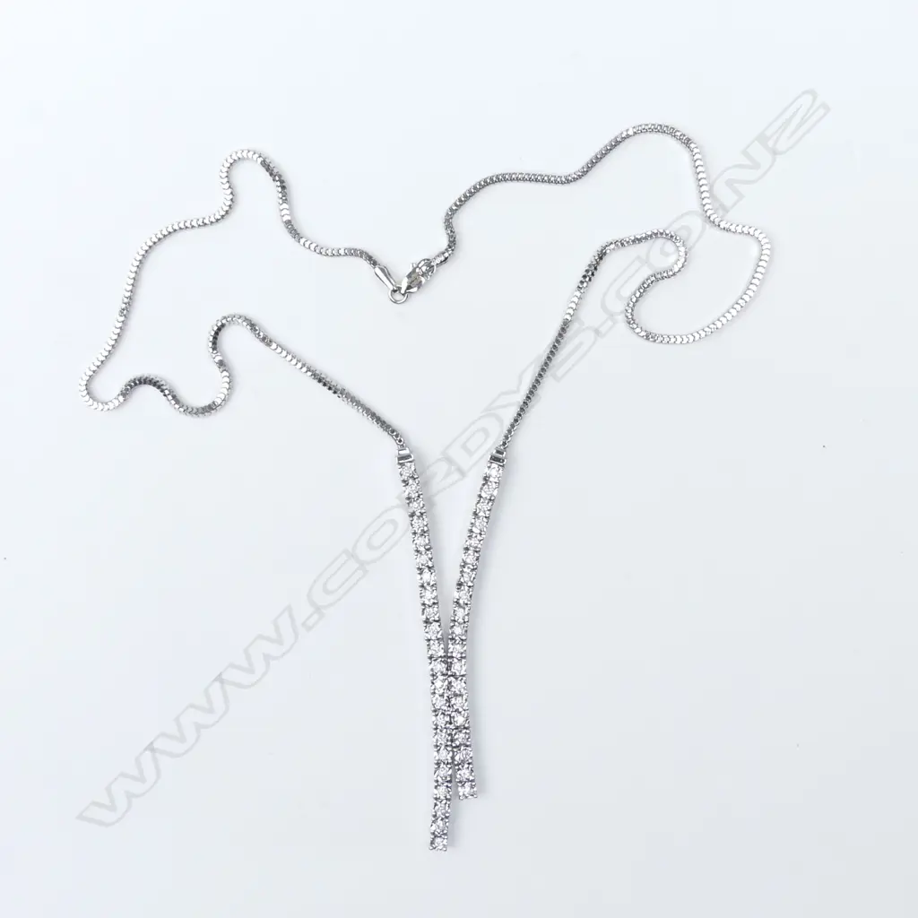 A 14ct white gold and diamond pendant and earrings set Image 1++