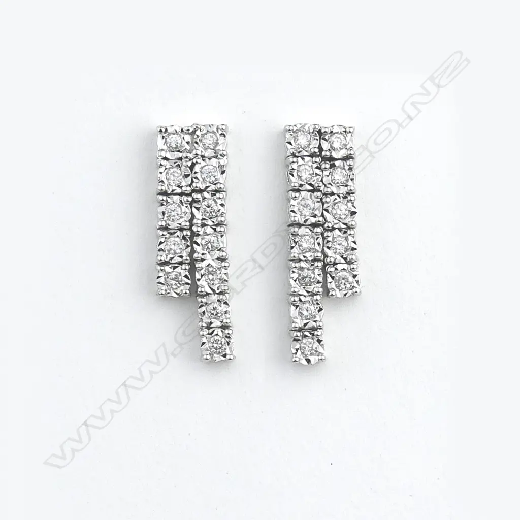 A 14ct white gold and diamond pendant and earrings set Image 1++