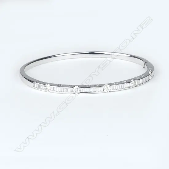 An 18ct white gold and diamond bangle