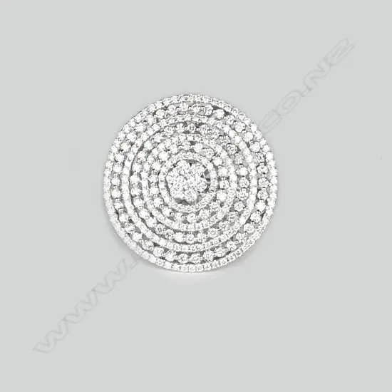 A lady's modern 18ct. white gold and multi-diamond set large disc form ring