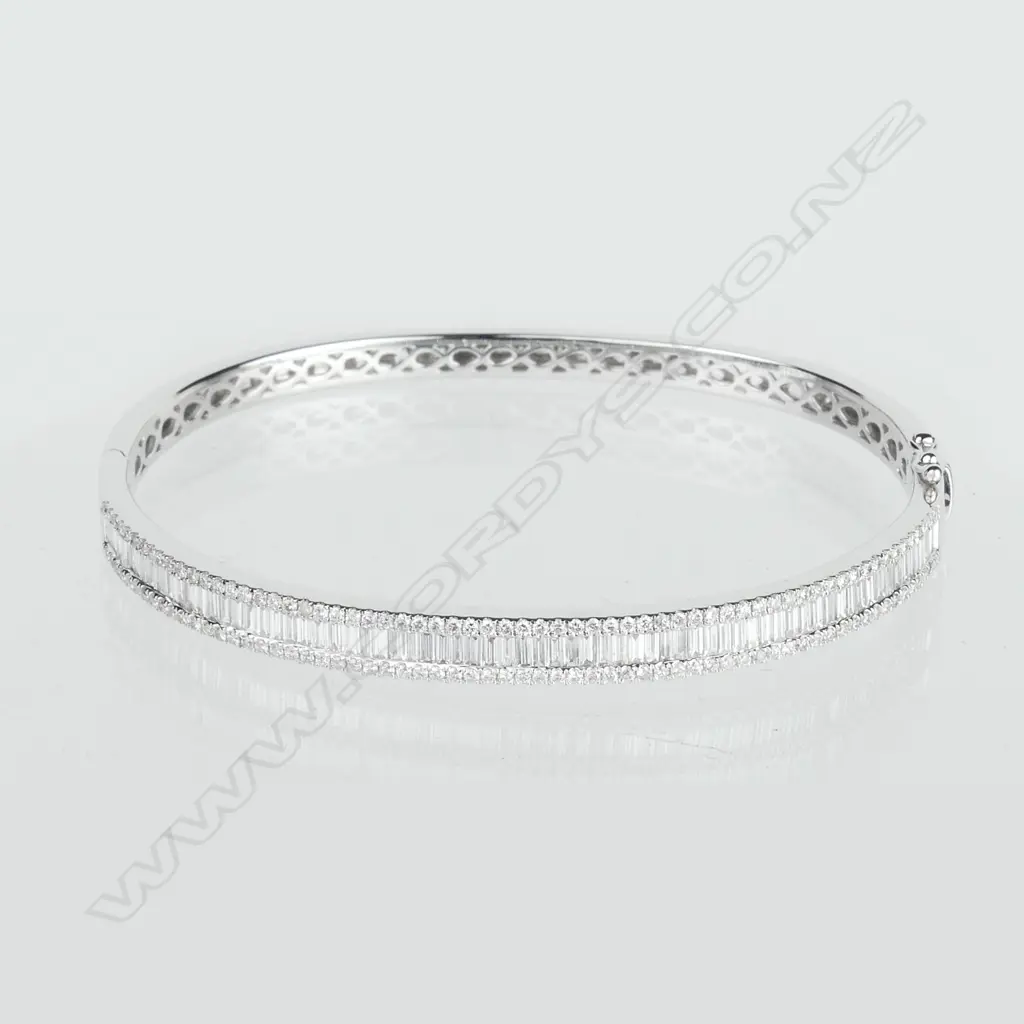 A lady's 18ct. white gold and diamond set half-hinged bangle Image 1++