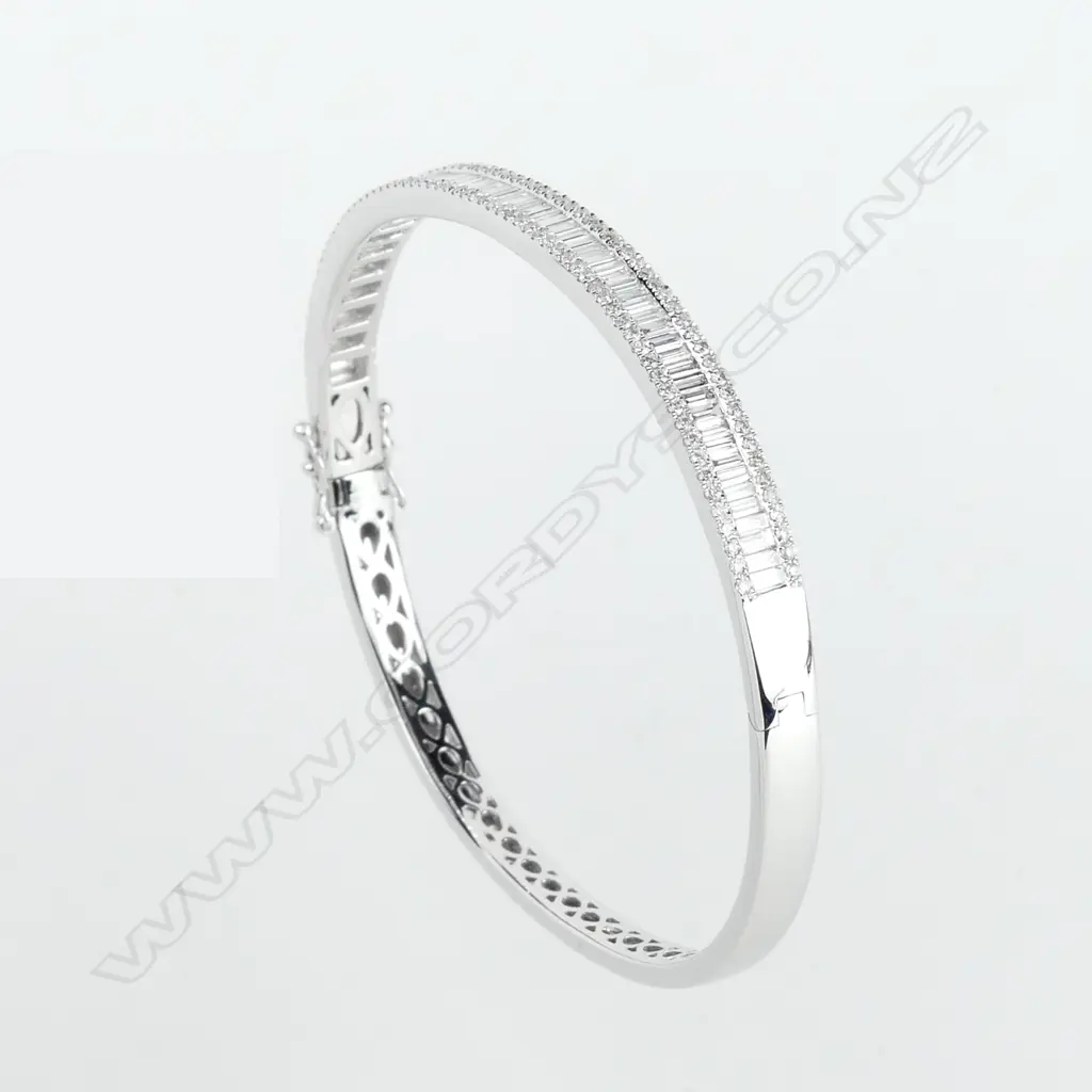 A lady's 18ct. white gold and diamond set half-hinged bangle Image 1++
