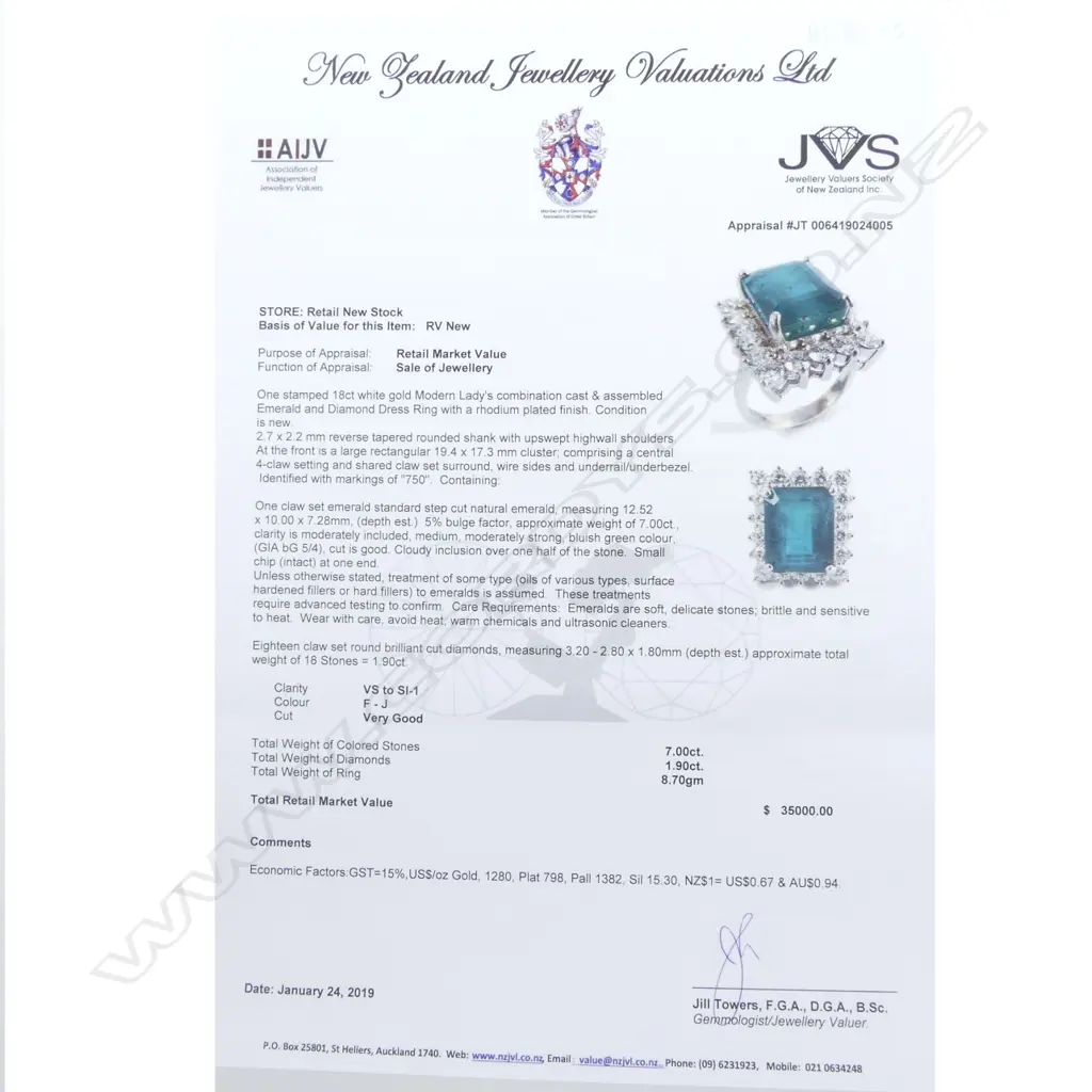 An 18ct white gold emerald and diamond ring Image 1++