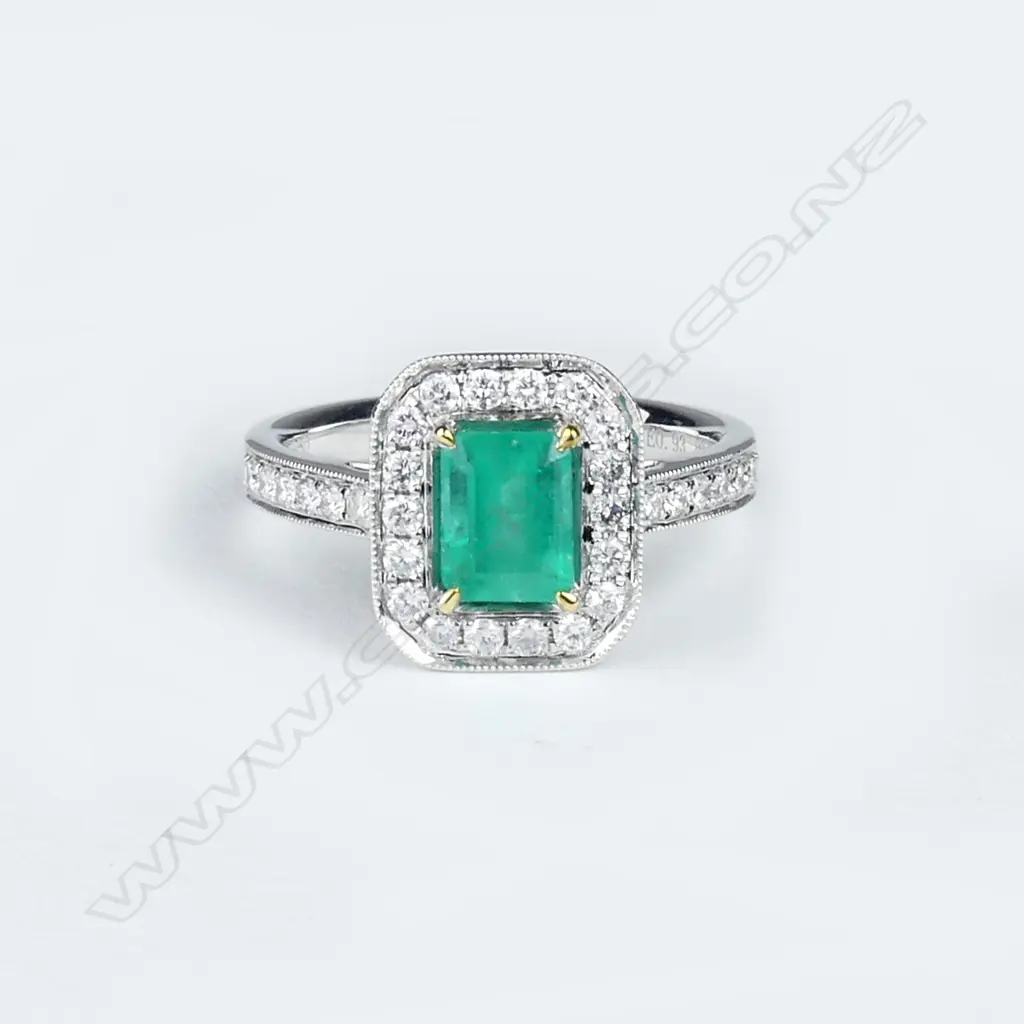 An 18ct white gold emerald and diamond ring Image 1++