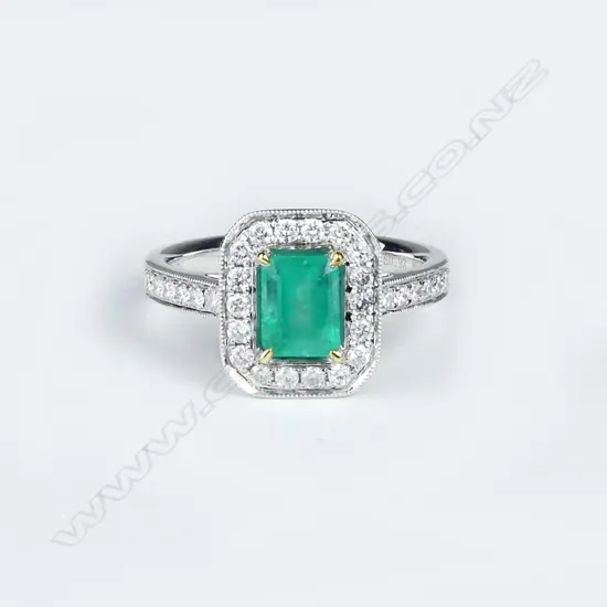 An 18ct white gold emerald and diamond ring