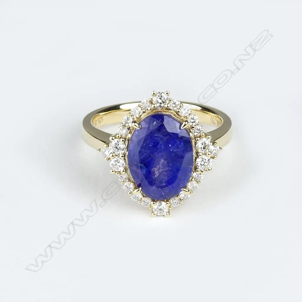 An 18ct gold tanzanite and diamond halo ring Image 1++