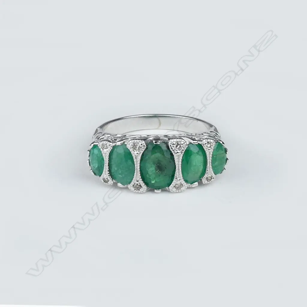 A 14ct white gold emerald and diamond ring Image 1++