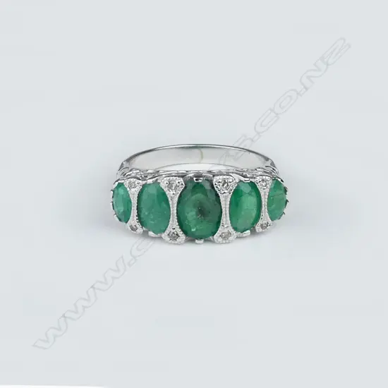 A 14ct white gold emerald and diamond ring