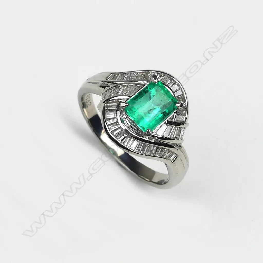 An emerald and diamond platinum set ring Image 1++