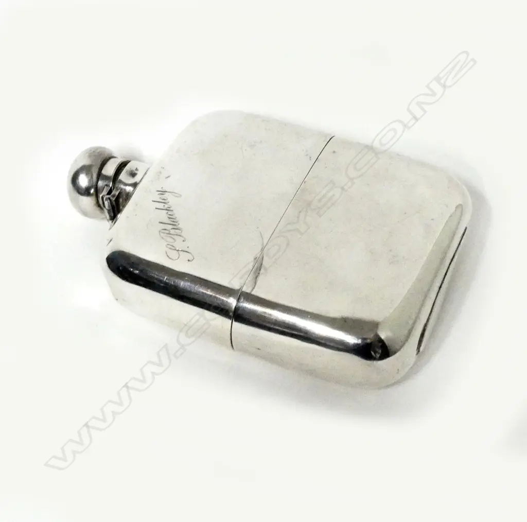 A silver hip flask Image 1++