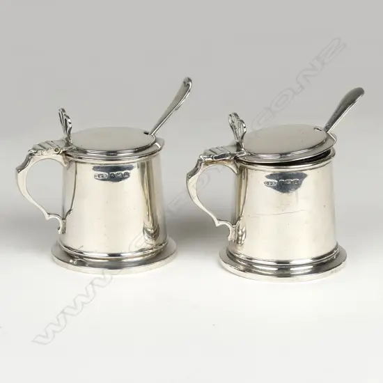 A pair of silver mustard pots