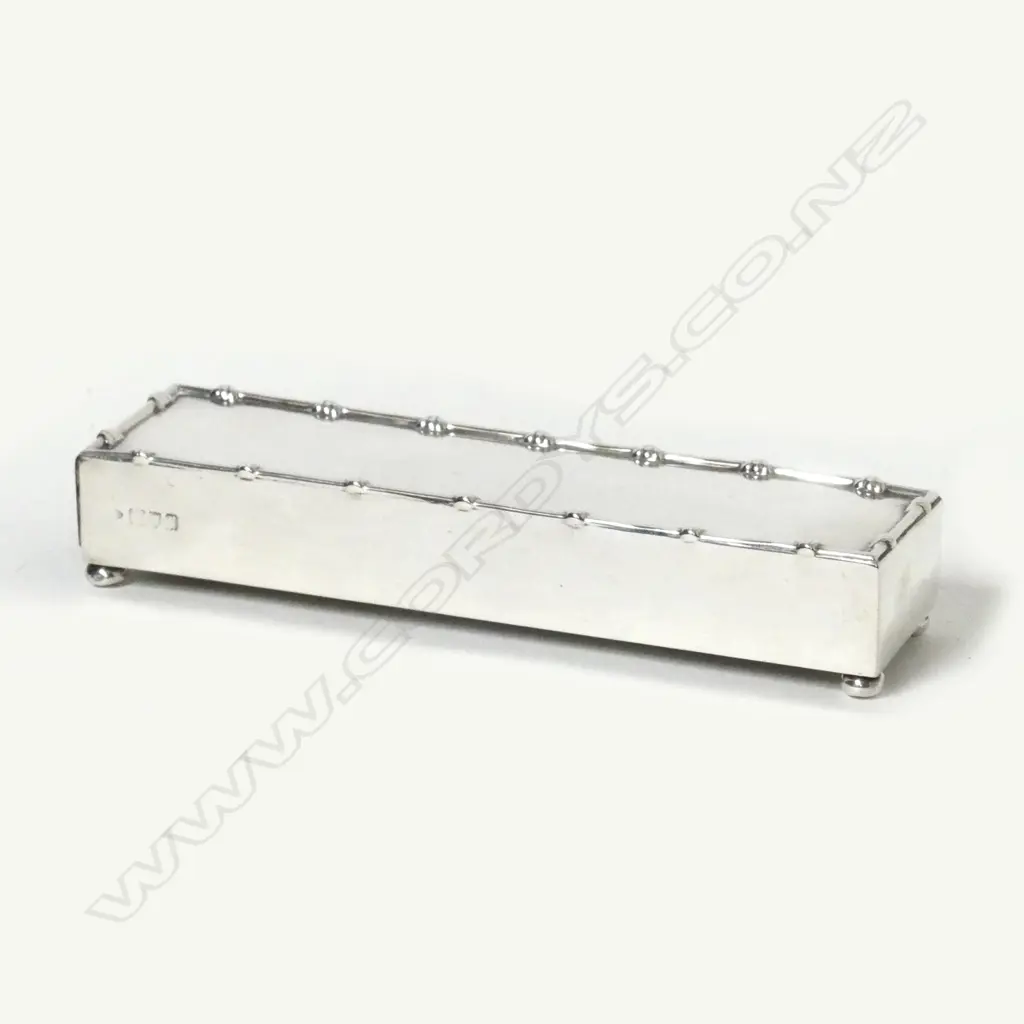 A silver match box frame Image 1++