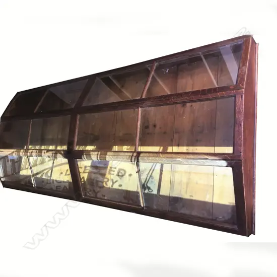 An uncommon c.1900 long oak counter top shop display cabinet