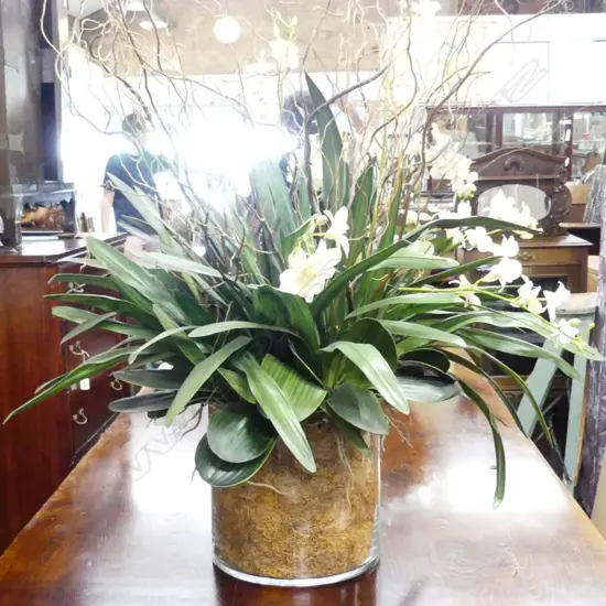 A large glass florist display vase