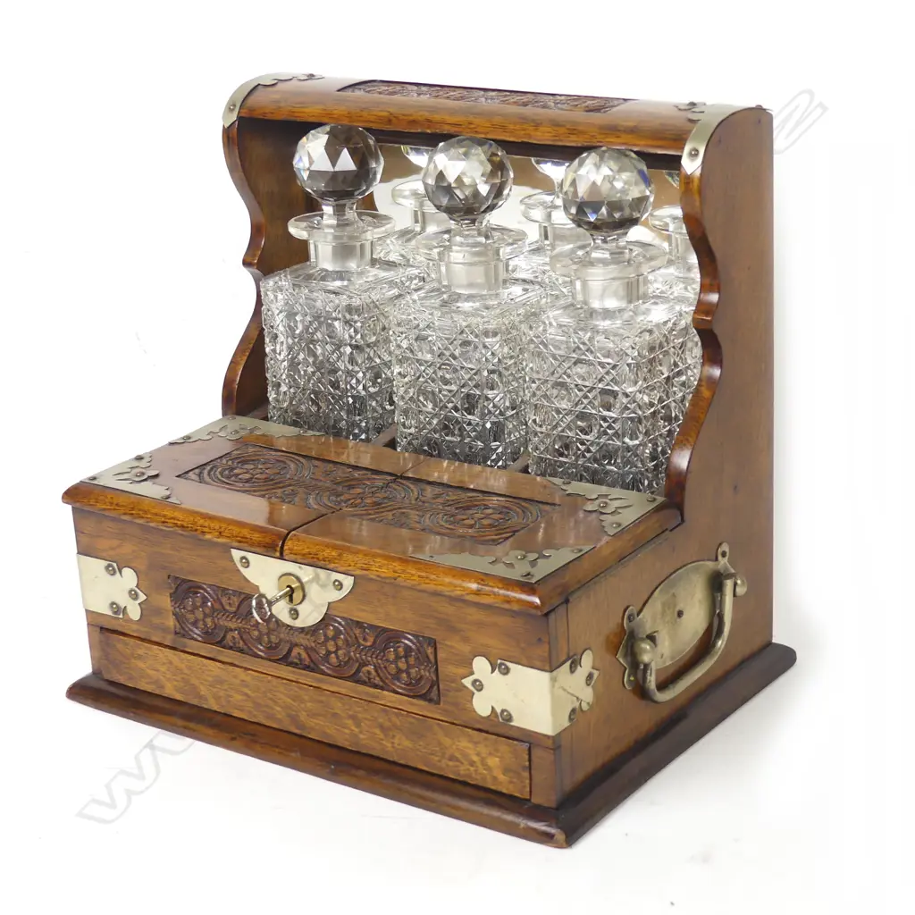 An Edwardian oak three-bottle tantalus Image 1++